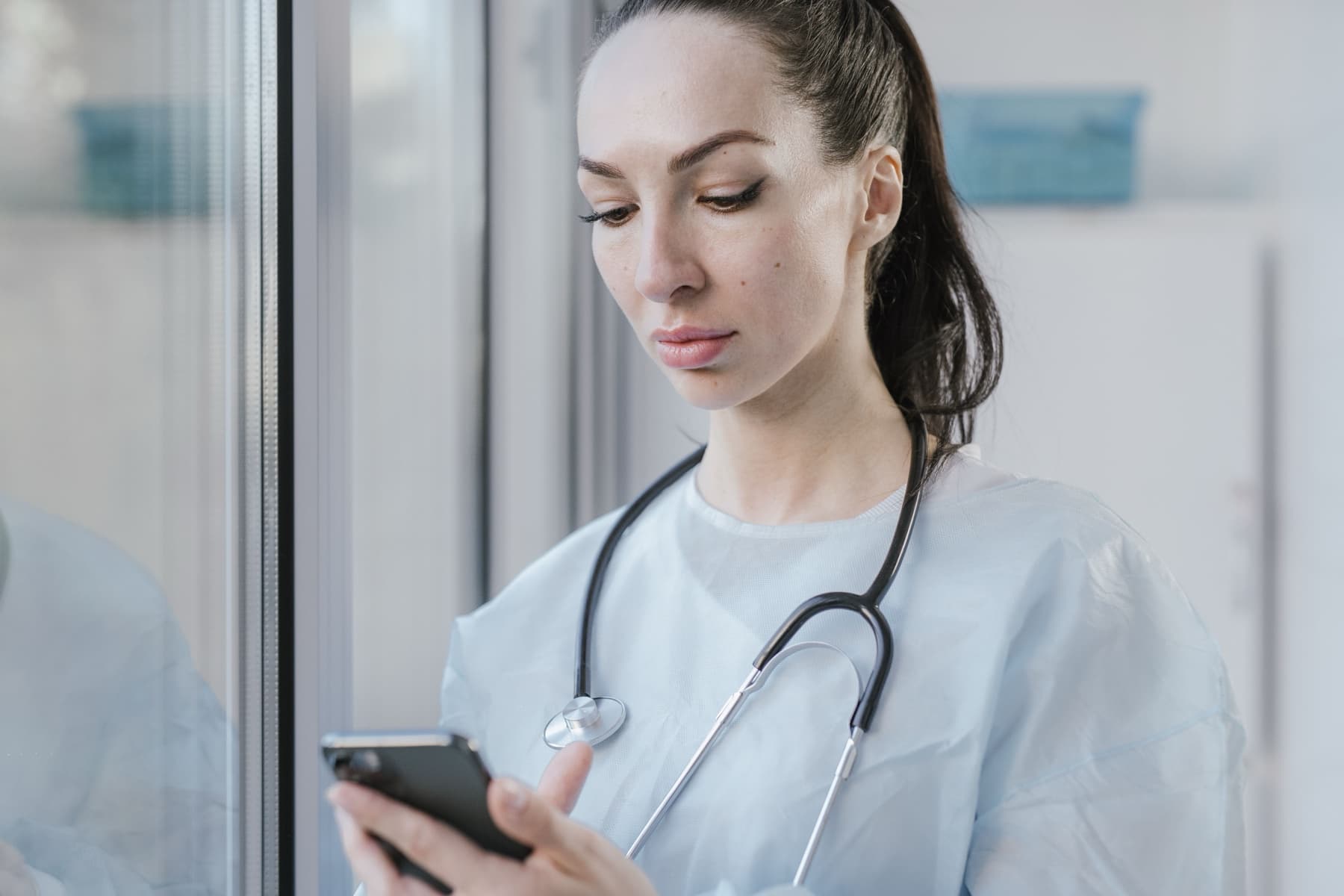 A clinician using a smartphone to message a patient