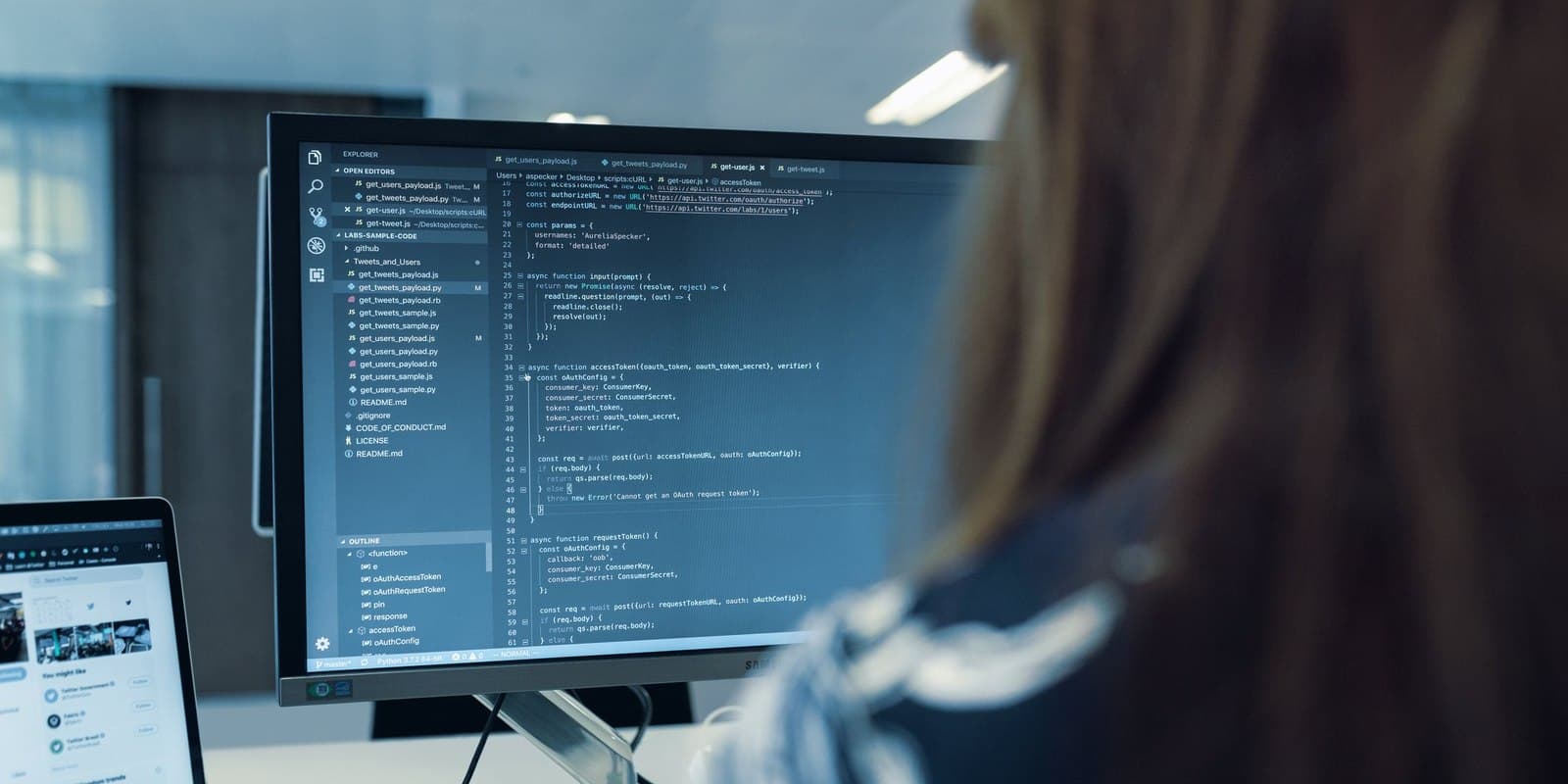 An engineer reading source on a large monitor