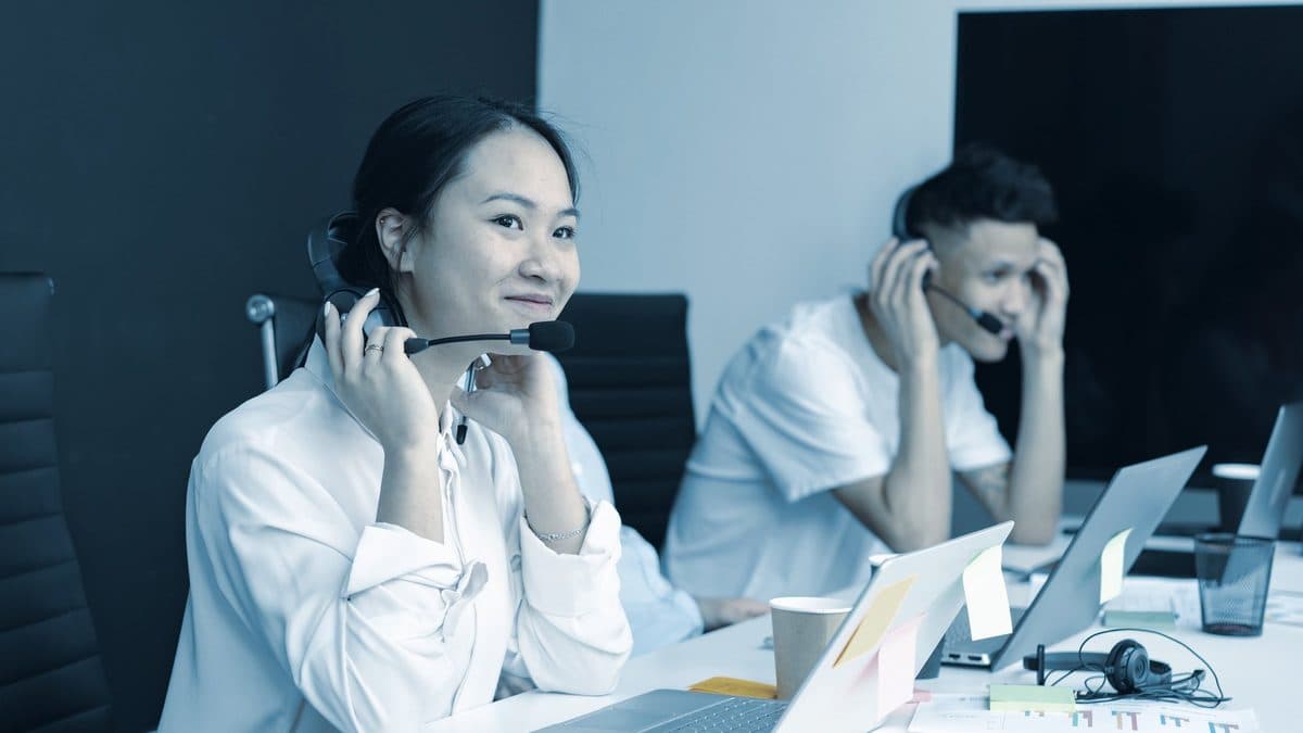 An intake coordinator answering a call at a front desk
