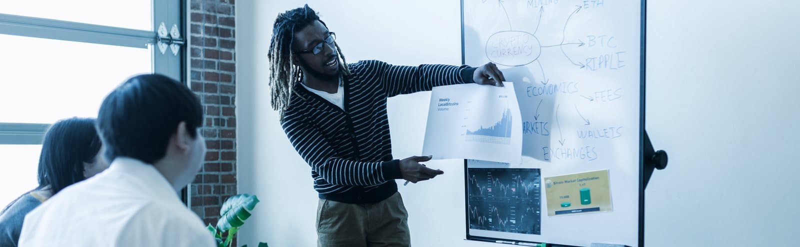 A consultant walking a team through a system diagram