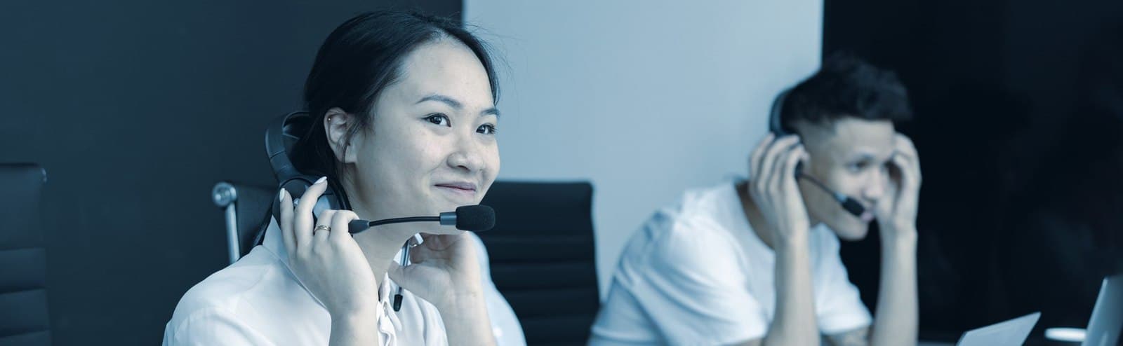 Sales agents working calls on headsets at their desks